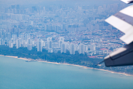 aerial view over Singapore and airplane wingsの写真素材