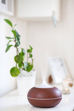 aroma oil diffuser on table at home. Air freshener