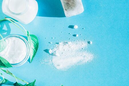 skin care with natural products baking soda,  coconut oil,  salt soap top view on bright blue...