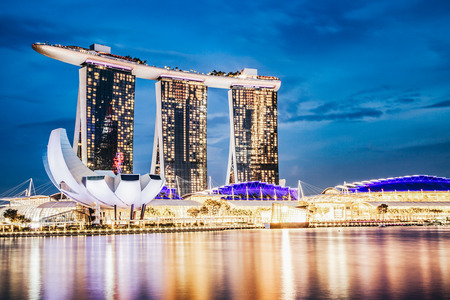 SINGAPORE, SINGAPORE - MARCH 2019: Skyline of Singapore Marina Bay at night with Marina Bay sands, Art Science museum and tourist boatsのeditorial素材