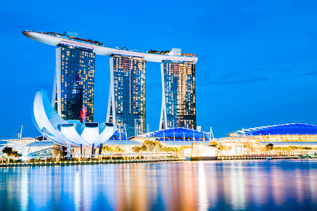 SINGAPORE, SINGAPORE - MARCH 2019: Skyline of Singapore Marina Bay at night with Marina Bay sands, Art Science museum and tourist boatsのeditorial素材