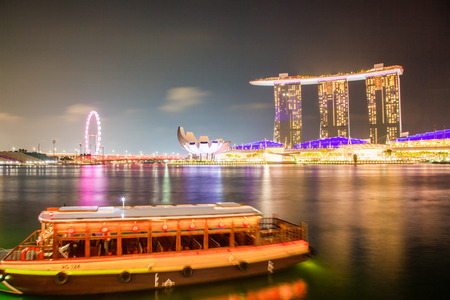 SINGAPORE, SINGAPORE - MARCH 2019: Skyline of Singapore Marina Bay at night with Marina Bay sands, Art Science museum and tourist boatsのeditorial素材