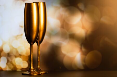 golden champagne glasses and fireworks at new yearの写真素材
