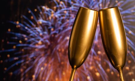 golden champagne glasses and fireworks at new yearの写真素材