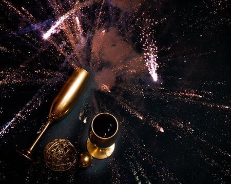 golden champagne glasses and fireworks at new yearの写真素材