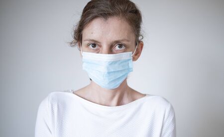 stop coronavirus woman wearing medical mask and raising hand 2019-nCoV fight - spreadingの写真素材