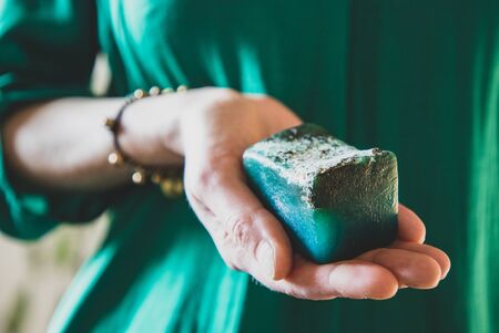 woman holding a home made soap vegan cosmeticsの写真素材
