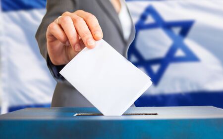 israel elections hand putting vote in ballotの写真素材