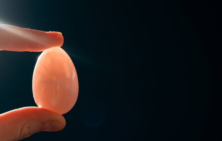woman holding a pink quartz yoni eggの写真素材