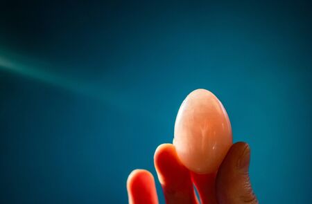 woman holding a pink quartz yoni eggの写真素材