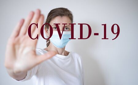 stop coronavirus woman wearing medical mask and raising hand 2019-nCoV fight - spreadingの写真素材
