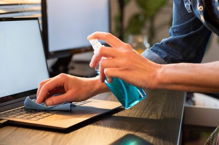 sanitizing computer or laptop keyboard coronavirus protectionの写真素材