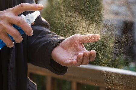 spraying hand sanitizer coronavirus preventionの写真素材