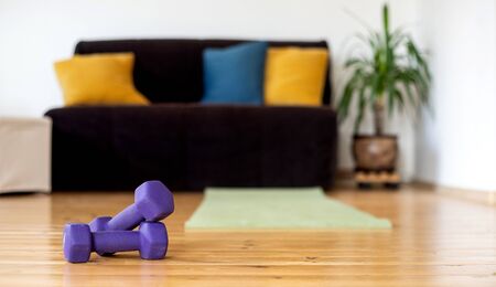 stay fit indoors dumbbells in living roomの写真素材