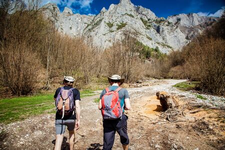 two men trekking in mountain scenery in summer