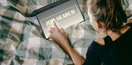 woman looking for a job. Job search on laptop and smartphone screenの写真素材