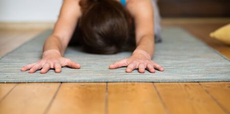 woman doing yoga at home mental health mindfulnessの写真素材
