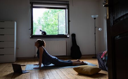 woman doing yoga at home mental healthの写真素材