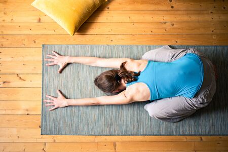 woman doing yoga at home mental health mindfulnessの写真素材