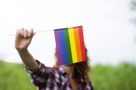 woman holding rainbow flag LGBT rightsの写真素材