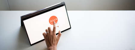 online shopping hand pressing sale button on tabletの写真素材