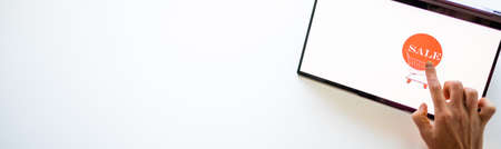 online shopping hand pressing sale button on tabletの写真素材