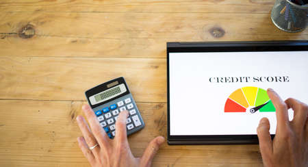 online finances hand pressing credit score button on tabletの写真素材