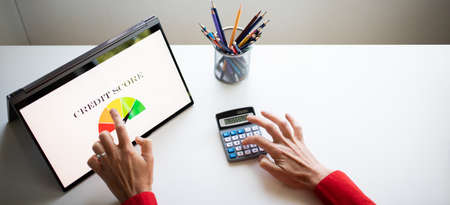 online finances hand pressing credit score button on tabletの写真素材
