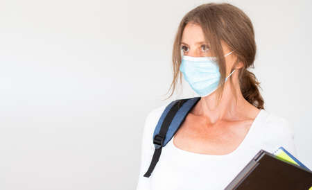 woman with mask laptop and notebooksの写真素材