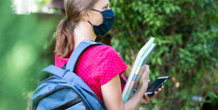 woman with mask laptop and notebooks outdoorsの写真素材