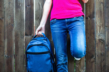 school kid feet in jeans and sneakers backpack  back to schoolの写真素材