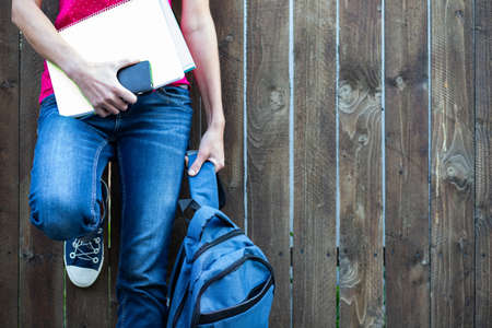 school kid feet in jeans and sneakers backpack  back to schoolの写真素材