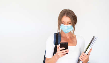 woman with mask laptop and notebooksの写真素材