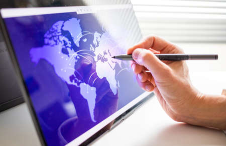 hand touching tablet screen global connection