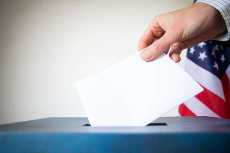 hand putting vote in ballot USA electionsの写真素材