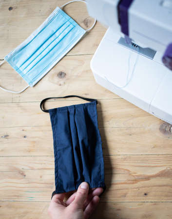 home made reusable masks on wooden table covidの写真素材