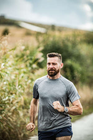young man running on country road