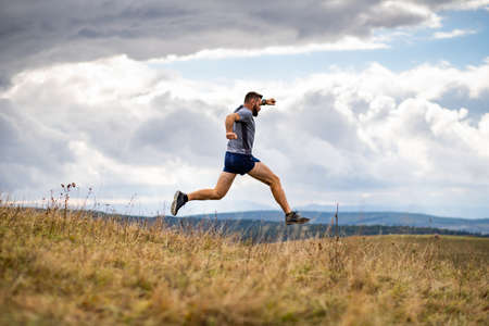 handsome trail runner running in nature