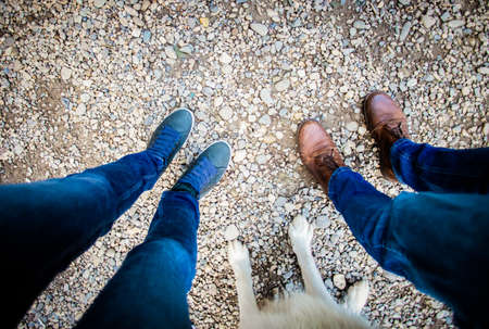 top view of couple feet and their dog
