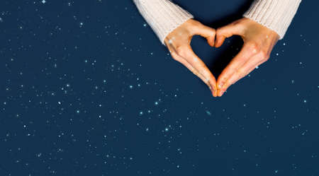 top view of female hands forming heart shape