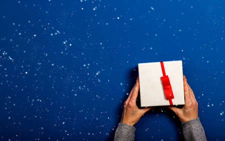 top view of female hands holding Christmas gift