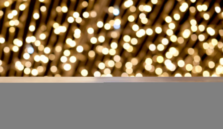 empty wooden desk space and Christmas lights in the background