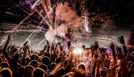 crowd with raised hands at concert festival bannerの写真素材