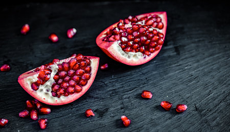 pomegranate pieces on black backgroundの写真素材