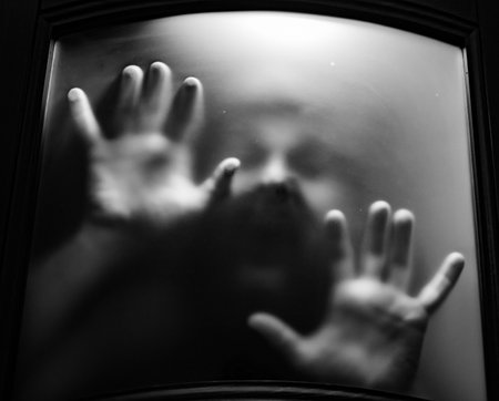 scary picture of hands behind glass