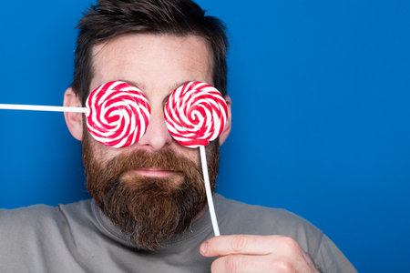 handsome man with lollipops colorful funny Valentine'sの写真素材