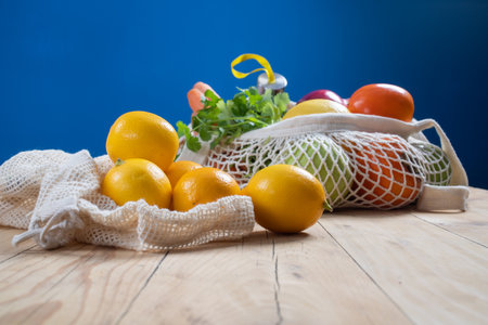 fresh fruits and vegetables in an eco bag. Zero waste, plastic free concept. Sustainable lifestyle. Reusable cotton and mesh eco bags for shoppingの写真素材
