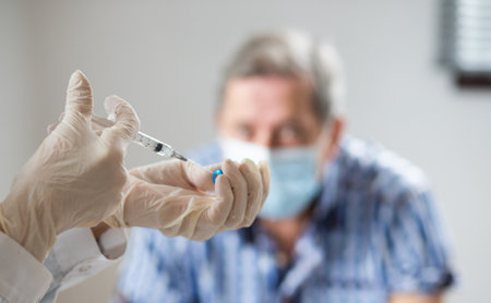 elderly man getting coronavirus vaccineの写真素材