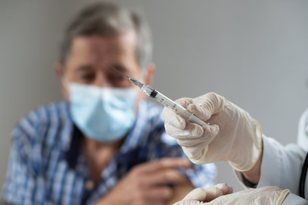 elderly man getting coronavirus vaccineの写真素材