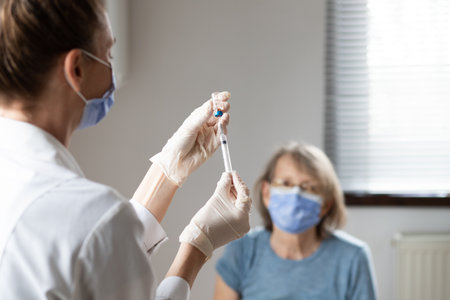 elderly woman getting coronavirus vaccineの写真素材